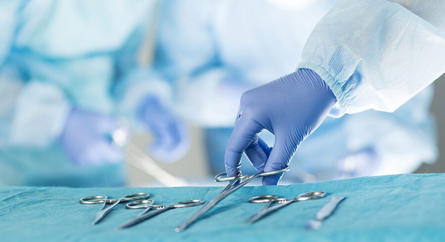 Close-up of scrub nurse taking medical instruments Emergency Pet Surgery